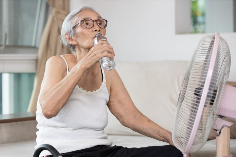 Older woman staying cool in the heat