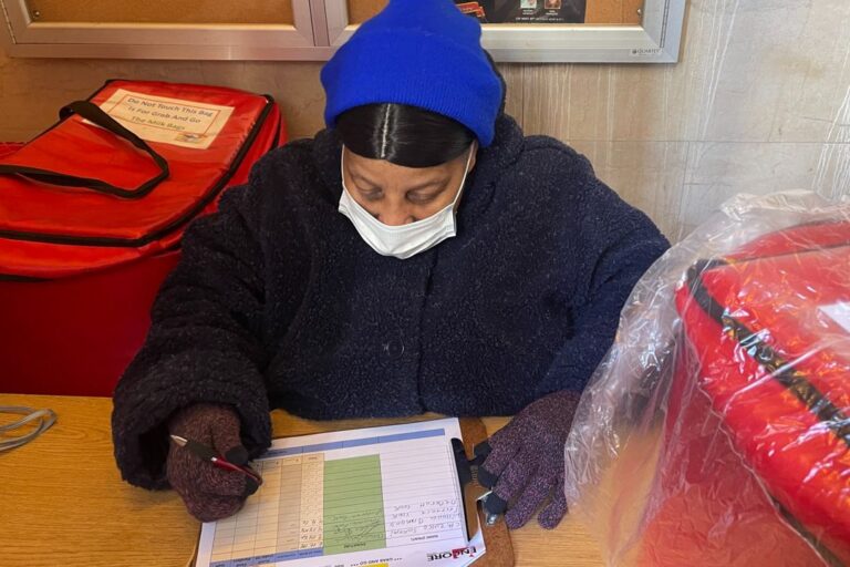 Phyllis Earle helps pack meals for seniors