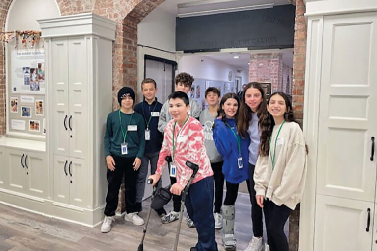 Group of students standing in front of a brick archway